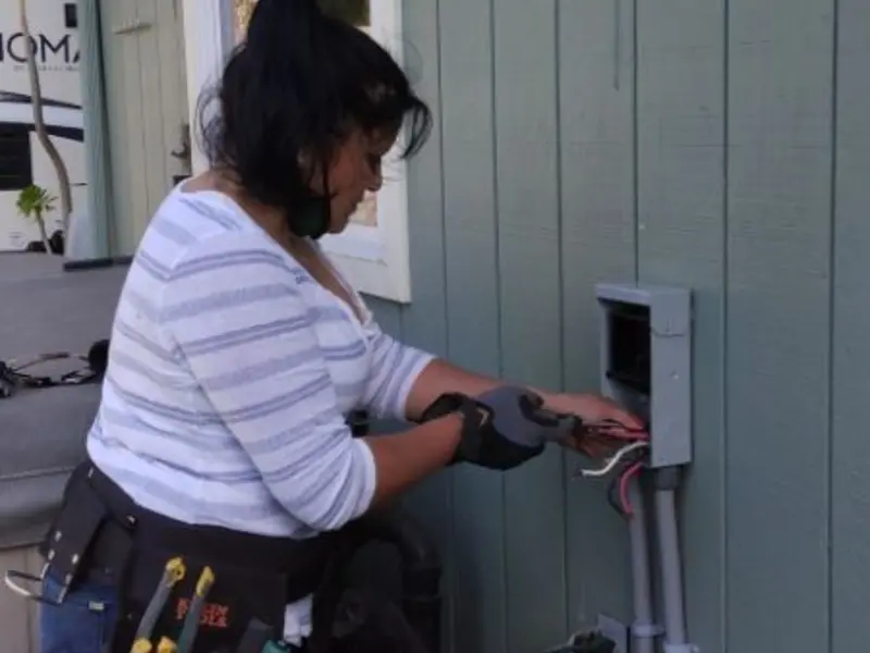 Licensed electrician wiring an exterior subpanel in Pleasanton